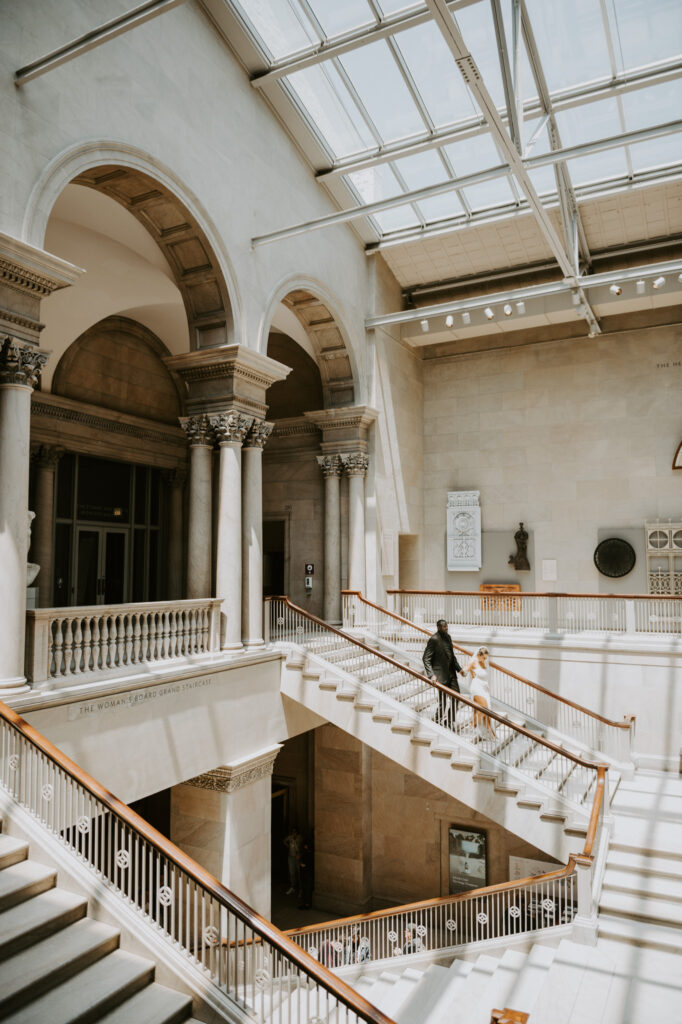 Couple walking down the stairs at the art institute chicago in an intimate celebration.