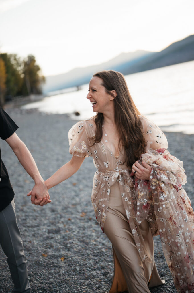 woman in floral wedding dress smiles at spouse out of frame