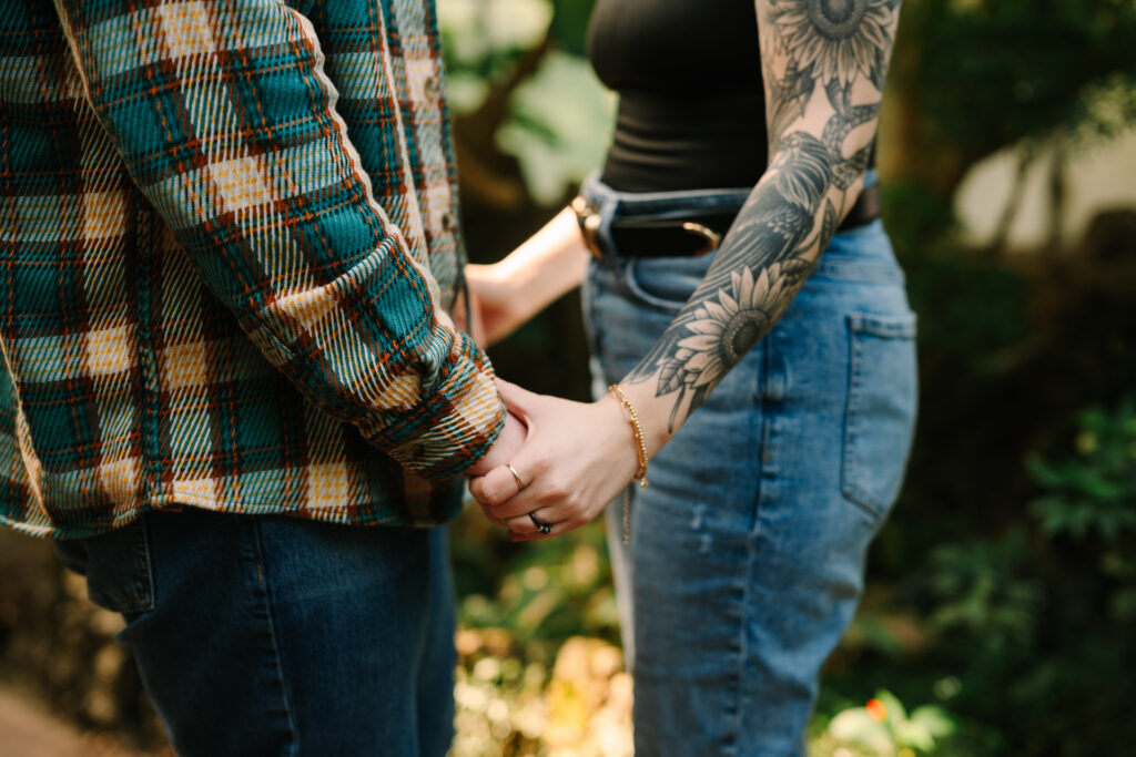 Couple holding hands during their Lincoln Park Conservatory engagement session in Chicago