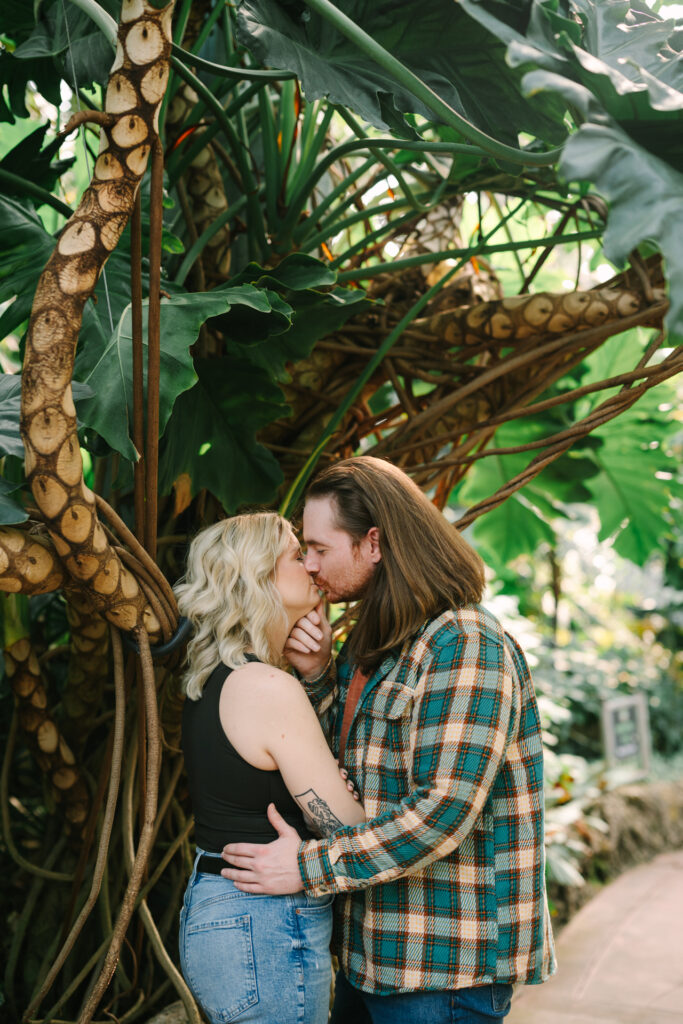 couple kisses at lincoln park conservatory engagement session