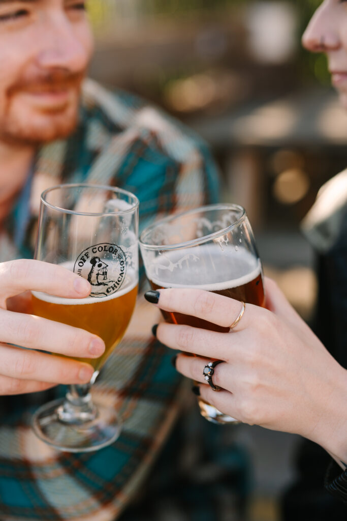 couple cheers during brewery engagement session
