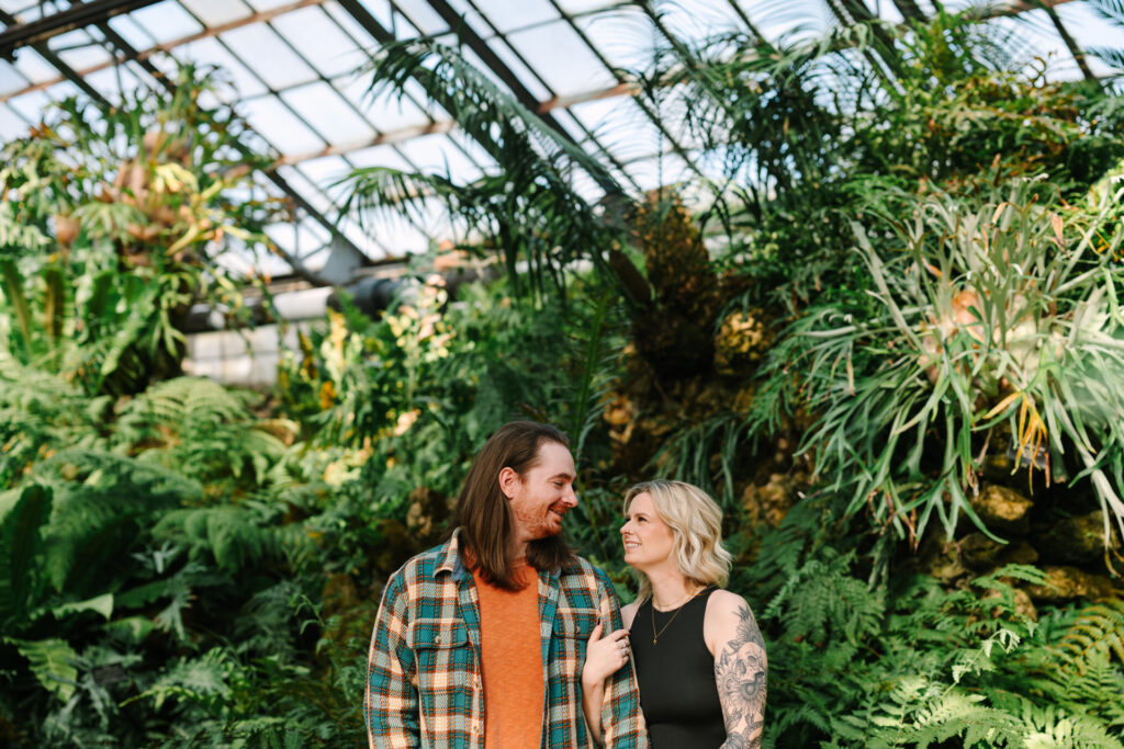 Couple holding hands during their Lincoln Park Conservatory engagement session in Chicago