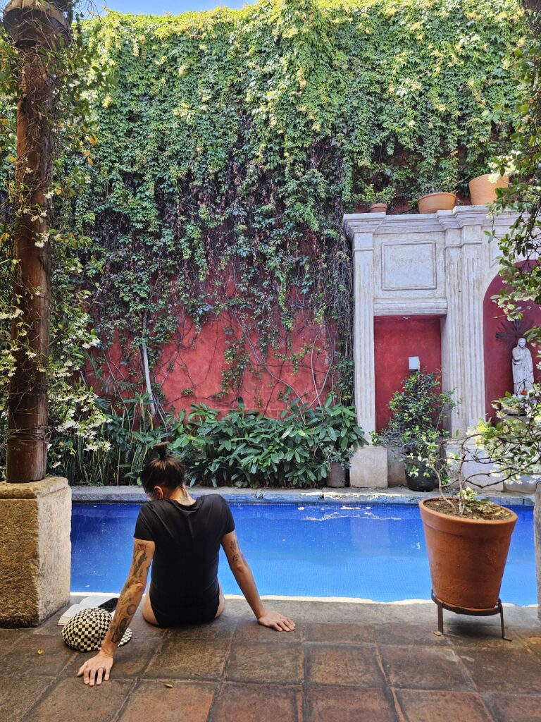 Woman poolside reading in Antigua Guatemala