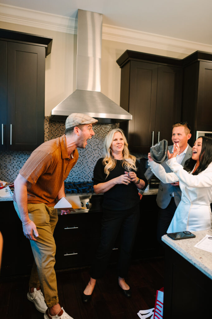Wedding guest reacts with shock and laughter in the kitchen after being asked to officiate a vow renewal at an intimate Chicago elopement reception